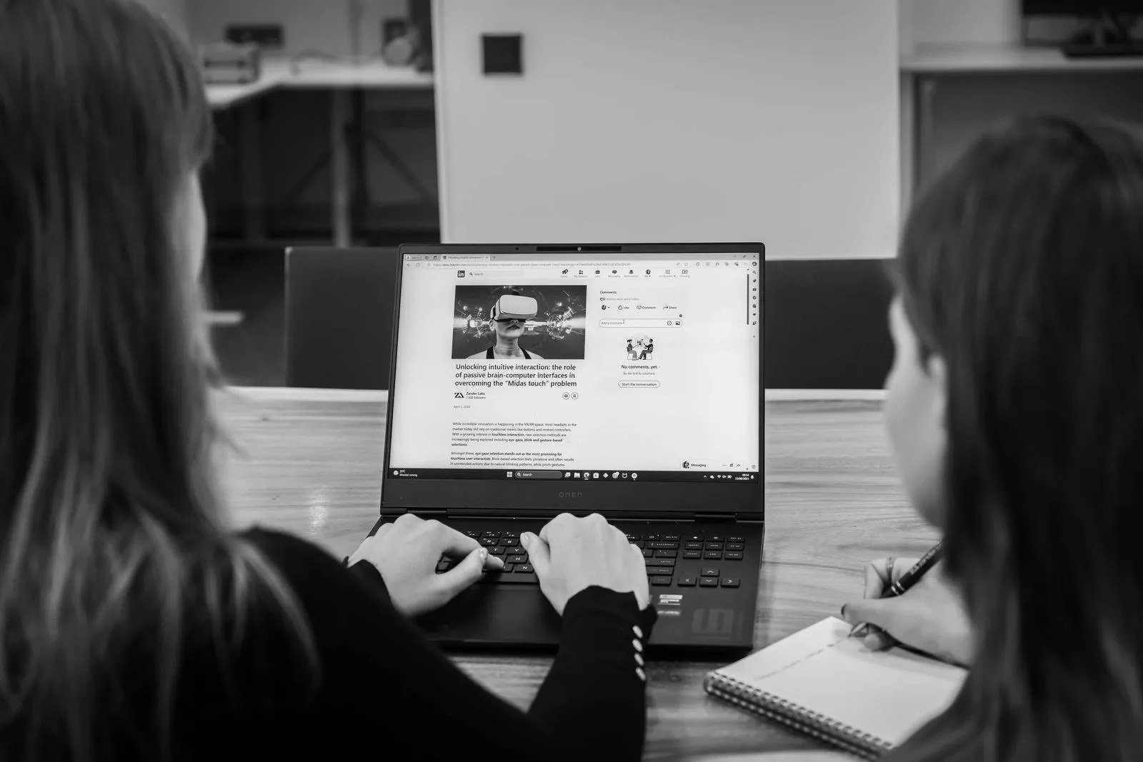 Researchers working together at a laptop in the Zander Labs Delft lab